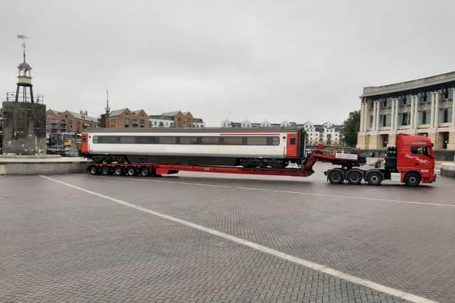 A train carriage could be seen on the back of a flatbed lorry by Lloyd Amphitheatre