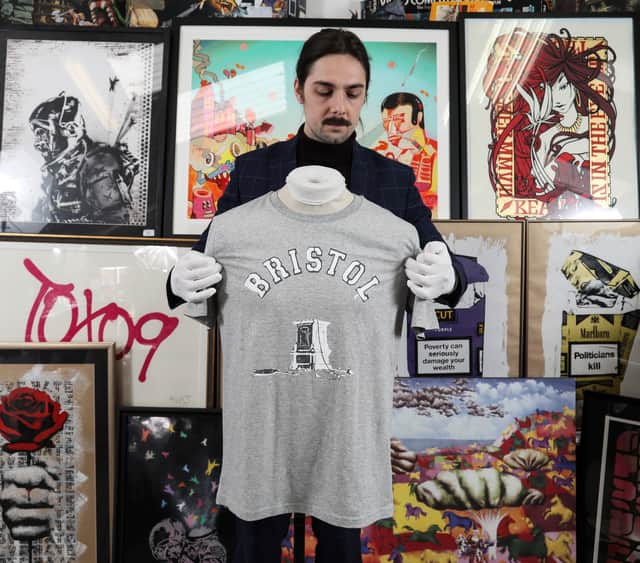 Jay Goodman-Browne of East Bristol Auctions with the T-shirt which sold for £12,000 at auction.