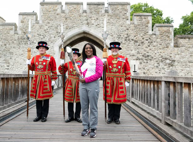 <p>Batonbearer Tessa Sanderson CBE carries the Queen’s Baton during the Birmingham 2022 Queen's Baton Relay at the Tower of London</p>