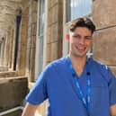 Oscar in scrubs on a placement during his time at the University of Bristol