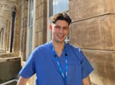 Oscar in scrubs on a placement during his time at the University of Bristol