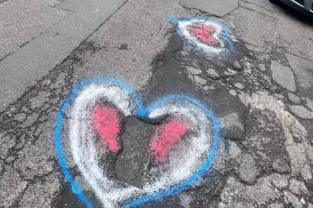Potholes in St Marks Road have been spray painted to highlight the issue