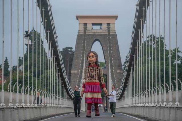 Little Amal crosses over the Clifton Suspension Bridge into Bristol this morning.