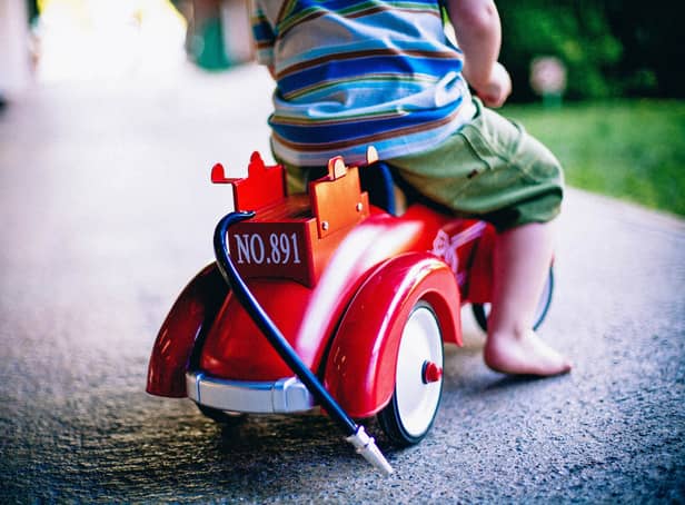 <p>Stock image of a child riding a toy scooter.</p>