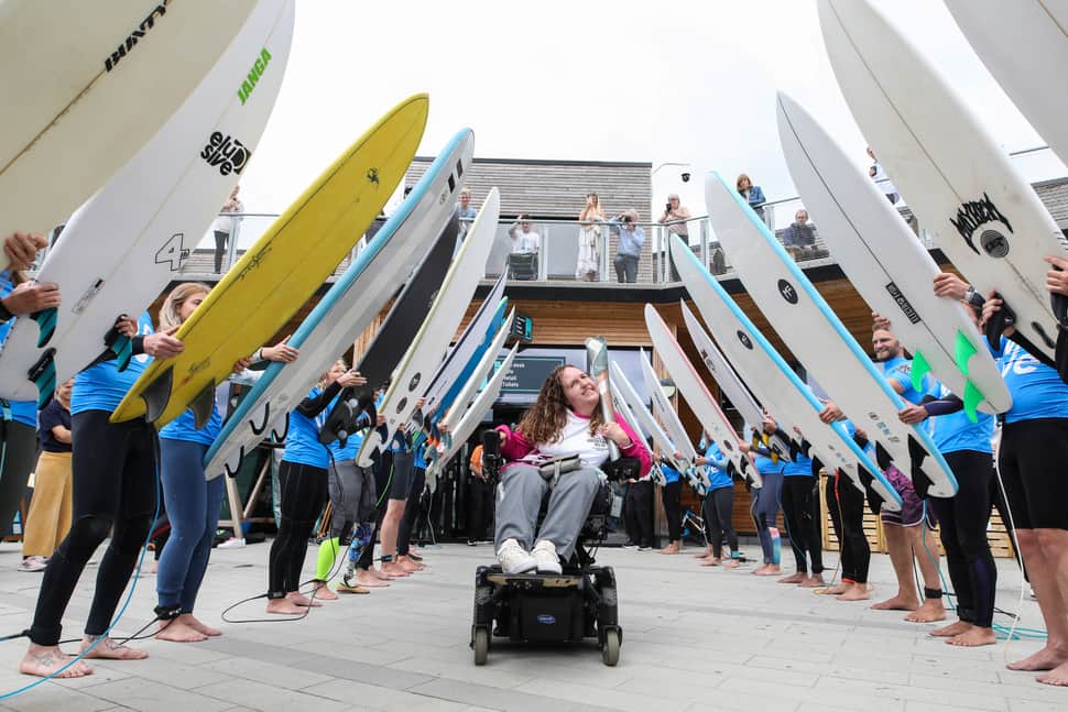 Queen’s Baton Relay taken for a surf at The Wave after arriving in Bristol