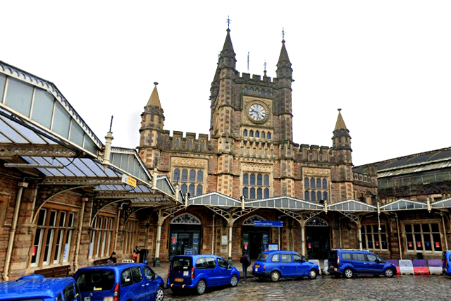 Blue taxis parked outside Bristol Temple Meads.