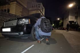 A tyre for a SUV is deflated by a climate activist in Clifton (Credit: Tyre Extinguishers)