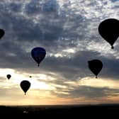 Hot air balloons take to the skies as they participate in the mass ascent at sunrise on the first day of the Bristol International Balloon Fiesta