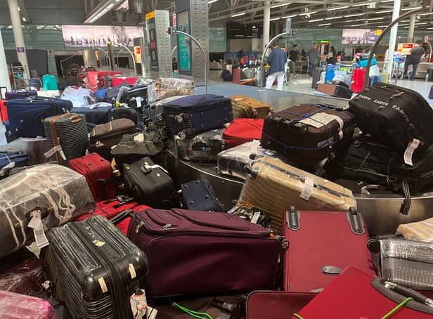 <p>Suitcases are seen uncollected at Heathrow’s Terminal Three baggage reclaim</p>