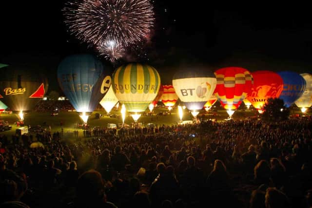 Hot air balloons are seen at the night glow at the International Balloon Fiesta in Bristol  (Photo by Matt Cardy/Getty Images).