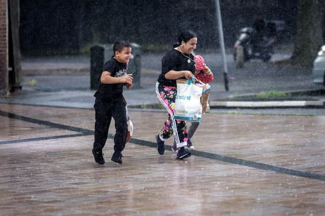 Shoppers brave a downpour - will Bristol see torrential downpours this week?