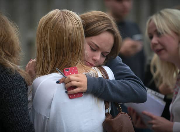 <p>Students at the Winterbourne International Academy react as they open their A-level results </p>