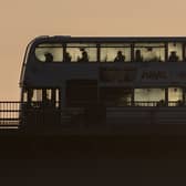 Passengers travel on a bus in the cold as the sun begins to rise in Bristol.