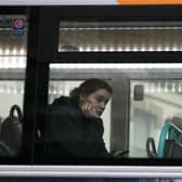 A woman looks out of the window of a First Bus in central Bristol.