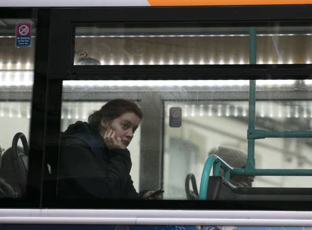 <p>A woman looks out of the window of a First Bus in central Bristol.</p>