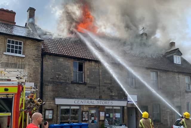 Firefighters tackling the blaze above a shop in Marshfield (Credit: @BrizaPie)