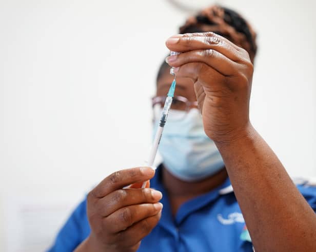  A nurse prepares a dose of a Covid-19 vaccine (Photo by  Jacob King - WPA Pool / Getty Images)