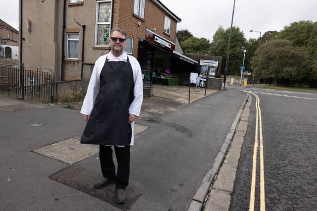 Dave John the butcher next to the double yellow lines that were painted by mistake in St Peters Rise, Headley Park.