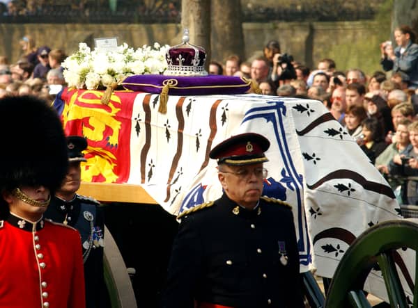 Soldiers accompany a gun carriage holding the coffin bearing the Queen Mother April 5, 2002.