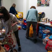 Volunteers are seen packing food parcels in March. With the cost of living rocketing in the UK,  food bank charitythe Trussell Trust estimate more than 5,100 food parcels are provided to households every day. 