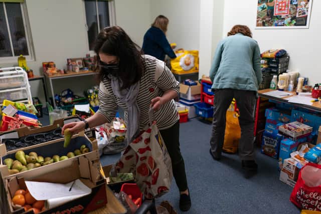 Volunteers are seen packing food parcels in March.. With the cost of living rocketing in the UK,  food bank charitythe Trussell Trust estimate more than 5,100 food parcels are provided to households every day. 