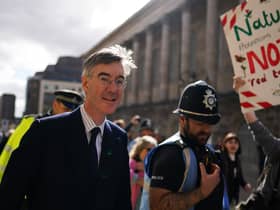 Jacob Rees-Mogg surrounded by police, walking through protestors as he arrived on the first day of the Conservative Party Conference