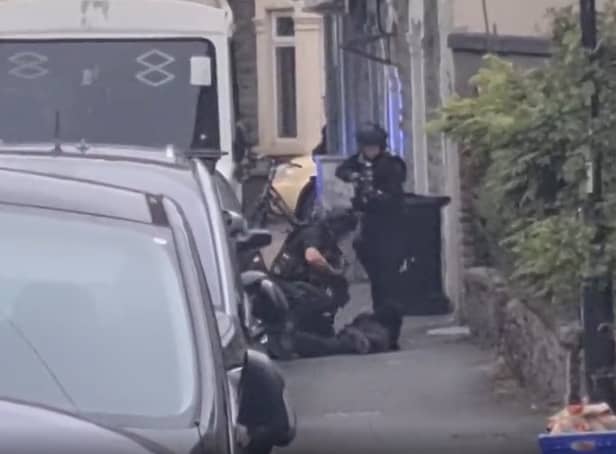 <p>Armed police arrest a man in Easton as neighbours watch on (Credit: Rob Bryher)</p>