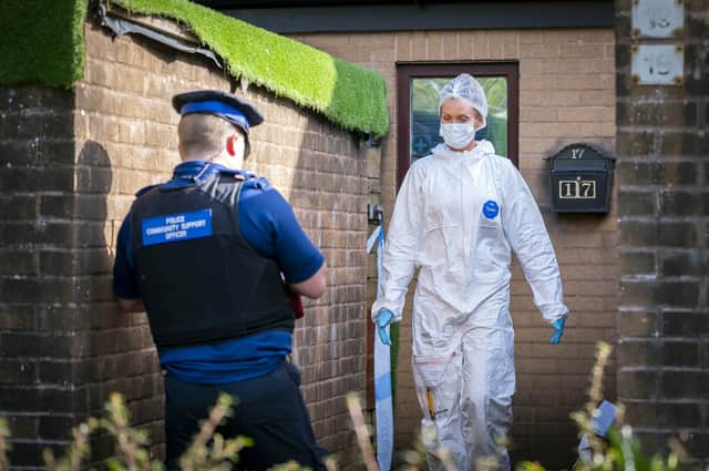 Forensic officers at the property in Parson Paddock