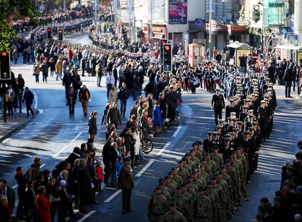 <p>Locals line the street as members of the armed forces and veterans march during a Remembrance Day in Bristol.</p>