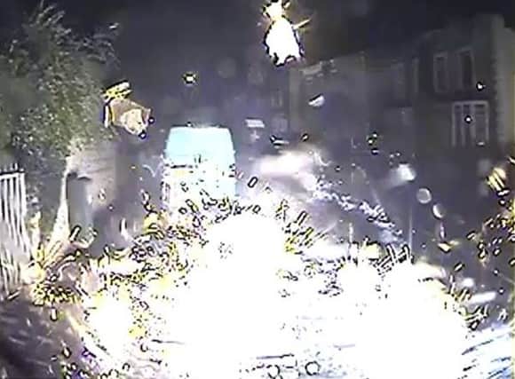 View from the driver’s seat as a firework goes off after hitting an ambulance