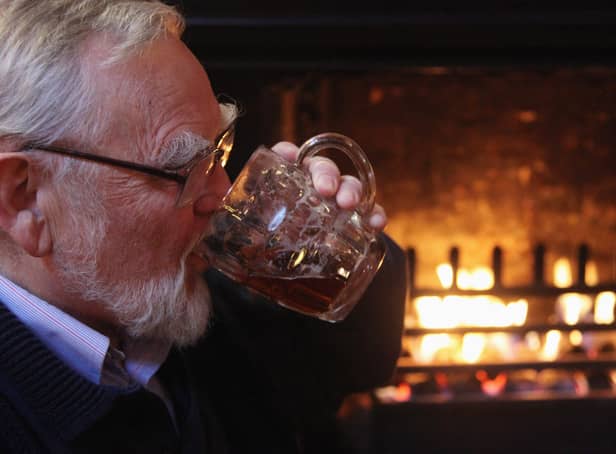 <p> A drinker enjoys a pint of beer which is currently being sold in outlets of the pub chain JD Wetherspoon for 99p a pint on January 5, 2009 in Bristol, England. </p>