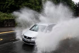 BRISTOL, ENGLAND - JUNE 18: A car drives through floodwater on Henbury Road on June 18, 2020, in Bristol, England. The Met Office have issued a yellow weather warning for the south-west of the UK for heavy rain and flooding. (Photo by Matthew Horwood/Getty Images)
