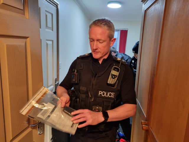 ‘I’m really happy’ - Sergeant Scott Minall with one of the mobiles phones seized
