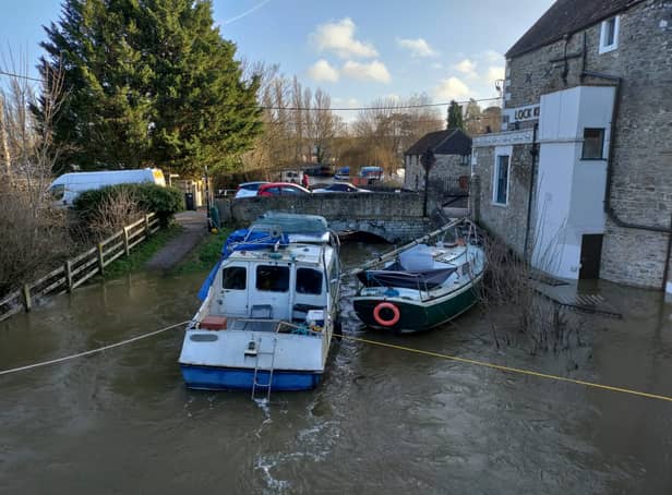 <p>A 38-foot boat become pinned against a bridge due to rising flood waters.</p>