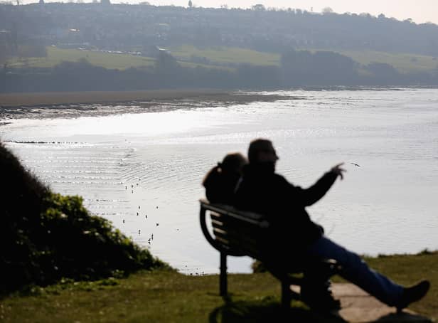 <p>People take in the view from the coastal path above the Severn Estuary at Portishead.</p>