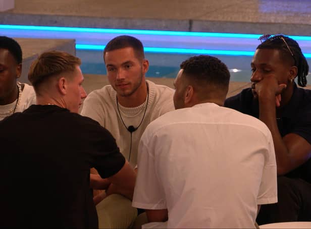 <p>The male islanders talking about the game, just before the drama erupted. (Photo by ITV)</p>