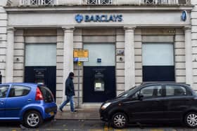 A man walks past a Barclays bank, in the Channel island's port capital Saint Helier, on December 11, 2022. (Photo by Sebastien SALOM-GOMIS / AFP) (Photo by SEBASTIEN SALOM-GOMIS/AFP via Getty Images)
