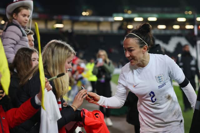 Lucy Bronze of England signs autographs following the Arnold Clark Cup match between England and Korea Republic at Stadium mk