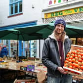 Chris Ennis, 28 at Reg the Veg grocers with tomatoes on sale