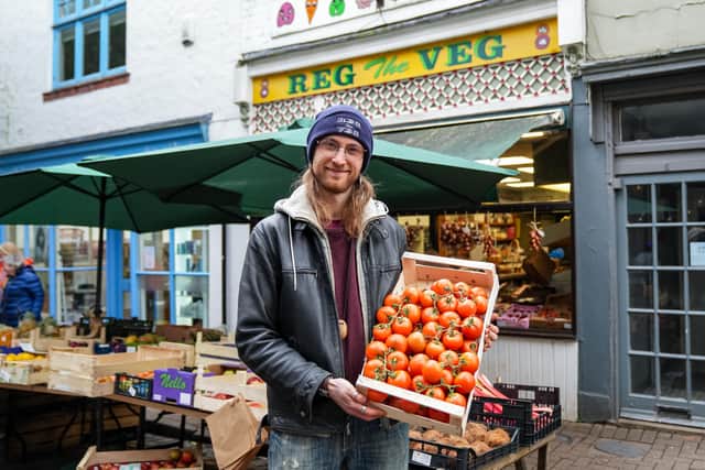 Chris Ennis, 28 at Reg the Veg grocers with tomatoes on sale