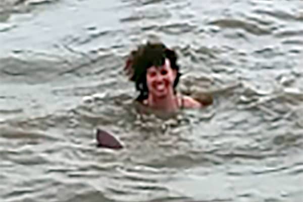 Claire Bye swimming with a dolphin in a river in Santa Rosa de Yacuma, Bolivia