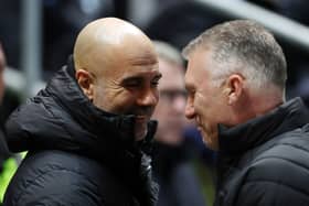 Pep Guardiola, Manager of Manchester City, shakes hands with Nigel Pearson, Manager of Bristol City, prior to the Emirates FA Cup Fifth Round match between Bristol City and Manchester City at Ashton Gate. (Photo by Catherine Ivill/Getty Images)