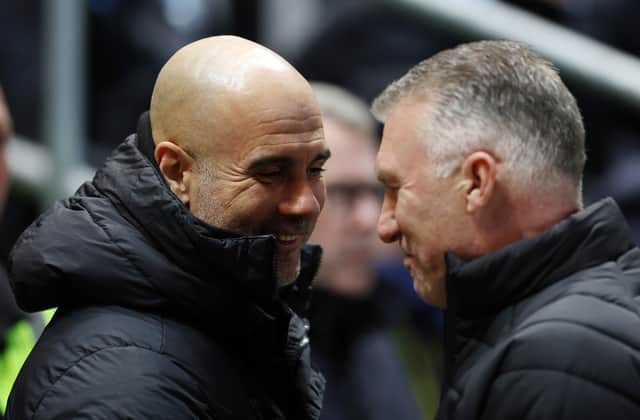 Pep Guardiola, Manager of Manchester City, shakes hands with Nigel Pearson, Manager of Bristol City, prior to the Emirates FA Cup Fifth Round match between Bristol City and Manchester City at Ashton Gate. (Photo by Catherine Ivill/Getty Images)