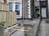 A police officer guards the property in Southville where a man died on Thursday