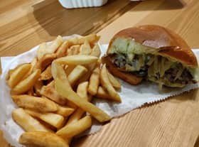 Inside the delicious Italian burger with the chips next to it from Dream Burger in Brislington