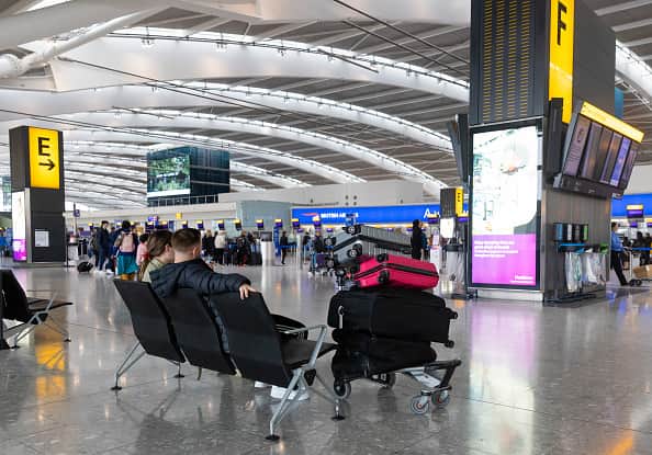 Passengers wait at the check-in area during a strike by security workers at London Heathrow Airport in London, UK, on Friday, March 31, 2023. 