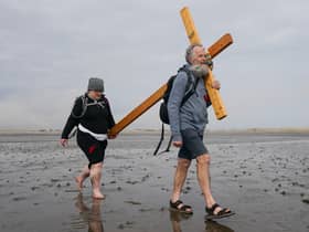  Pilgrims celebrate Easter by carrying wooden crosses as they walk over the tidal causeway to Lindisfarne during the final leg of their annual Good Friday pilgrimage.
