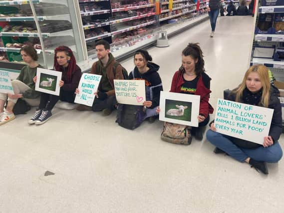 Animal Rebellion activists stage a peaceful protest in the meat aisle of Sainsbury’s at Clifton Down in Bristol