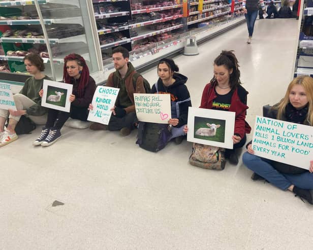 Animal Rebellion activists stage a peaceful protest in the meat aisle of Sainsbury’s at Clifton Down in Bristol