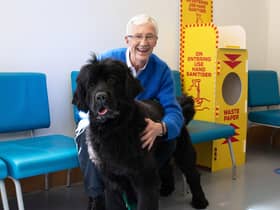Paul O'Grady at Battersea Cats and Dogs Home with Peggy a Newfoundland dog (Credit: ITV/Multistory Media)